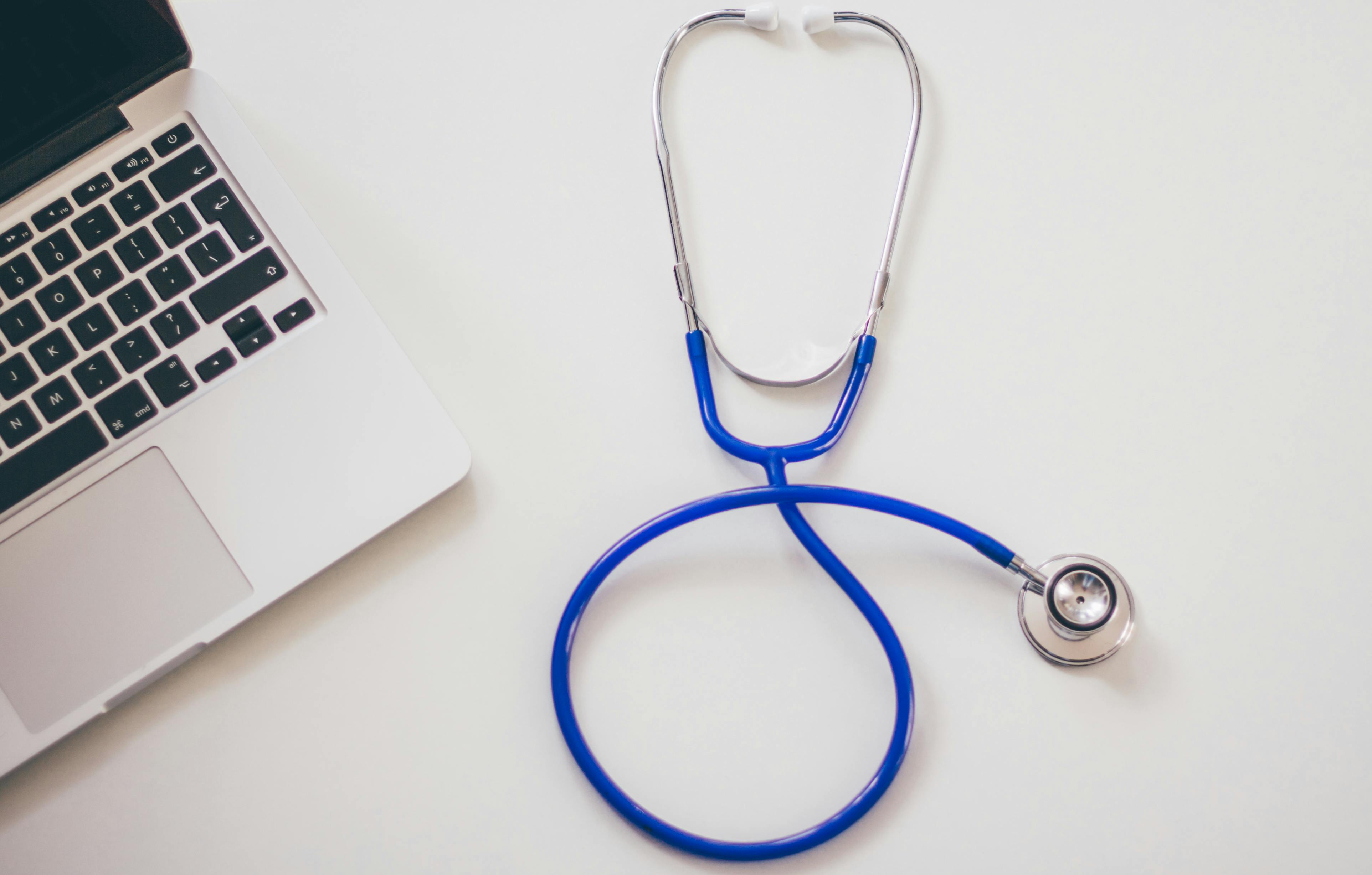 pexels-photo-48604-48604 Medical stethoscope and laptop on a white desk, symbolizing digital health solutions.